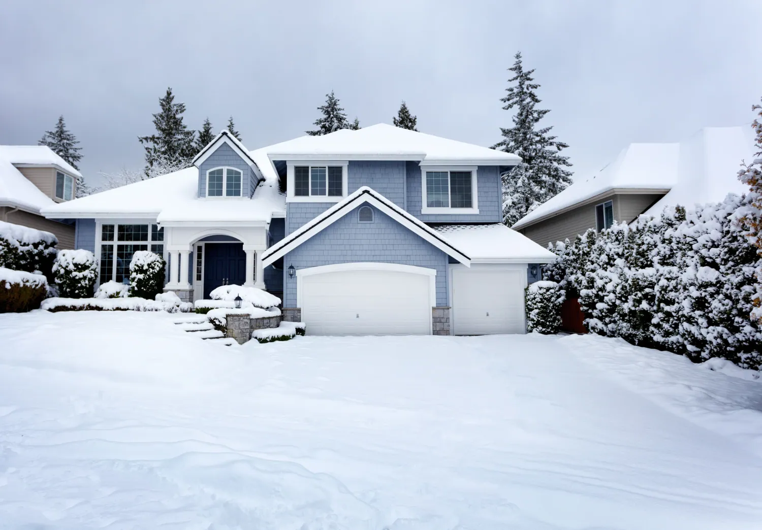 Clearing ice from a residential driveway in Anchorage